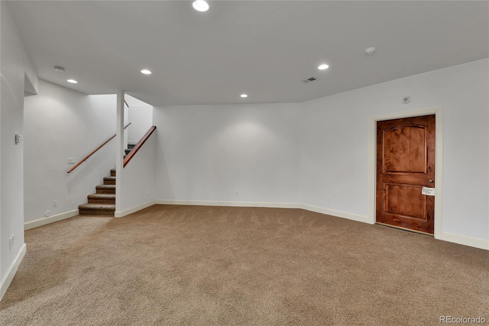 12984 Crowfoot Springs Road Franktown, CO 80116 - Photo 30 of 50 an empty room with windows and stairs