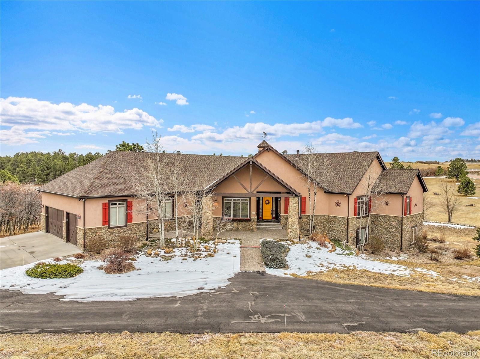 12984 Crowfoot Springs Road Franktown, CO 80116 - Photo 3 of 50 a view of a house with a patio