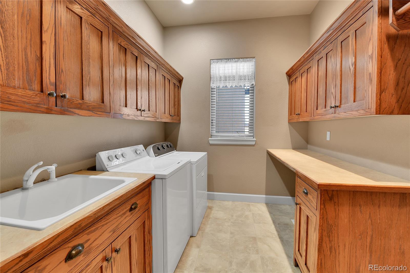 12984 Crowfoot Springs Road Franktown, CO 80116 - Photo 33 of 50 a utility room with dryer and washer