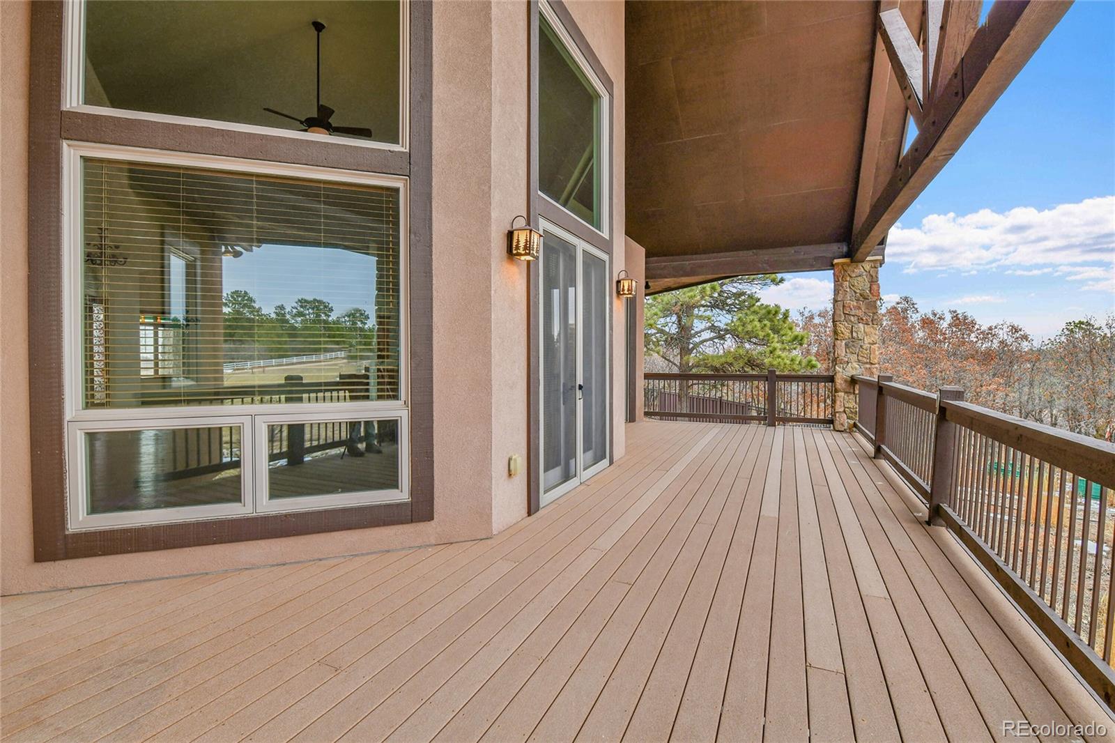12984 Crowfoot Springs Road Franktown, CO 80116 - Photo 36 of 50 a view of a balcony with wooden floor