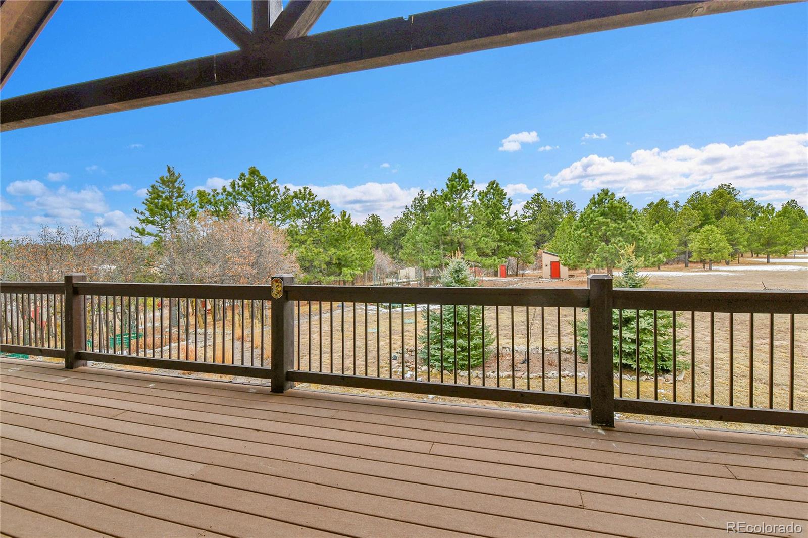 12984 Crowfoot Springs Road Franktown, CO 80116 - Photo 37 of 50 a view of balcony with wooden floor