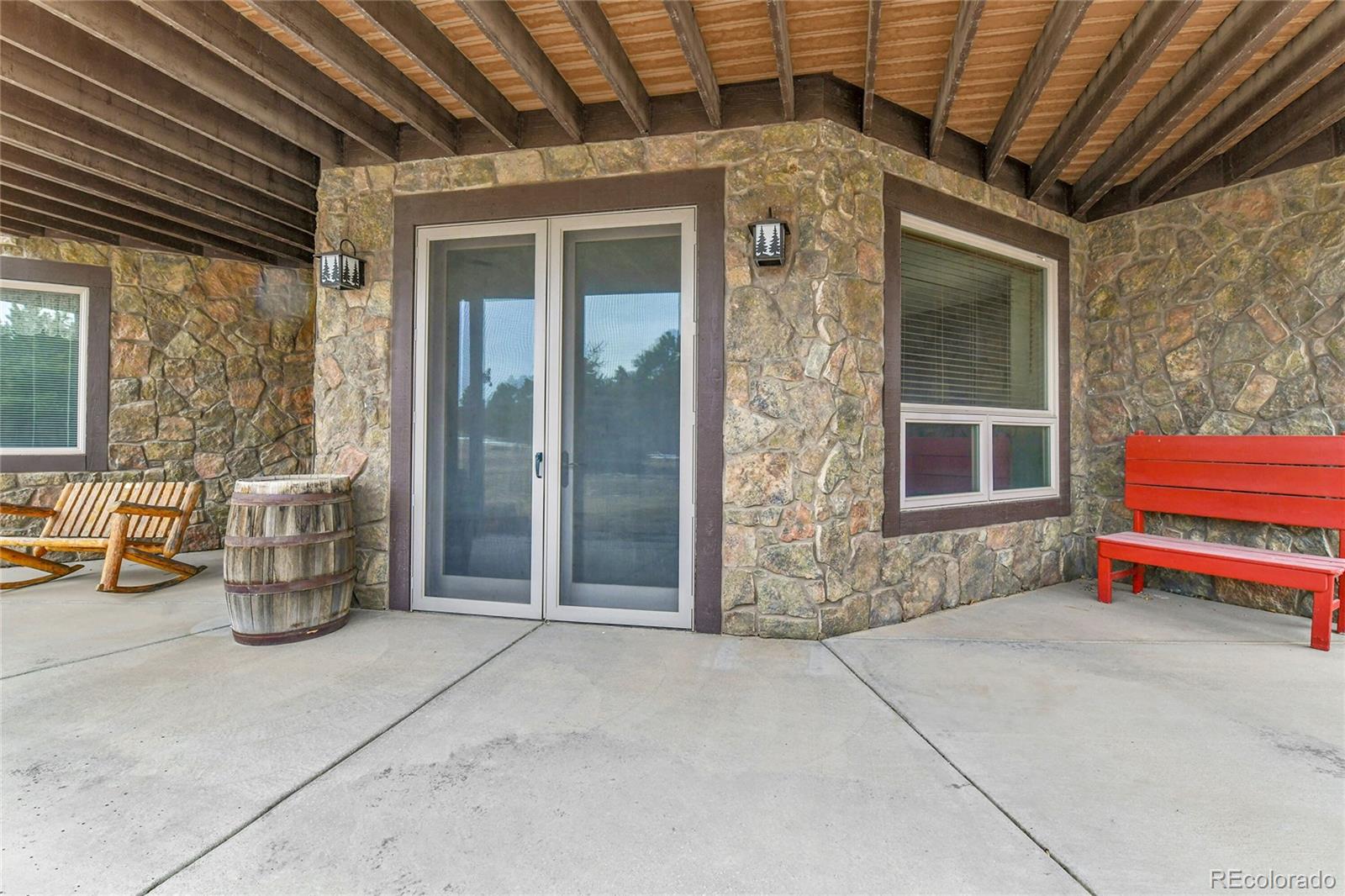 12984 Crowfoot Springs Road Franktown, CO 80116 - Photo 38 of 50 a backyard of a house with barbeque oven table and chairs
