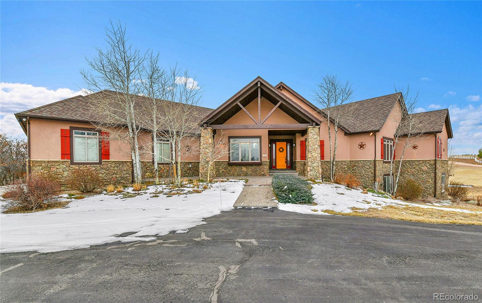12984 Crowfoot Springs Road Franktown, CO 80116 - Photo 4 of 50 a front view of a house with a outdoor space