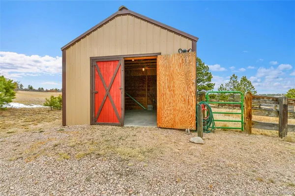 a view of a yard with wooden fence