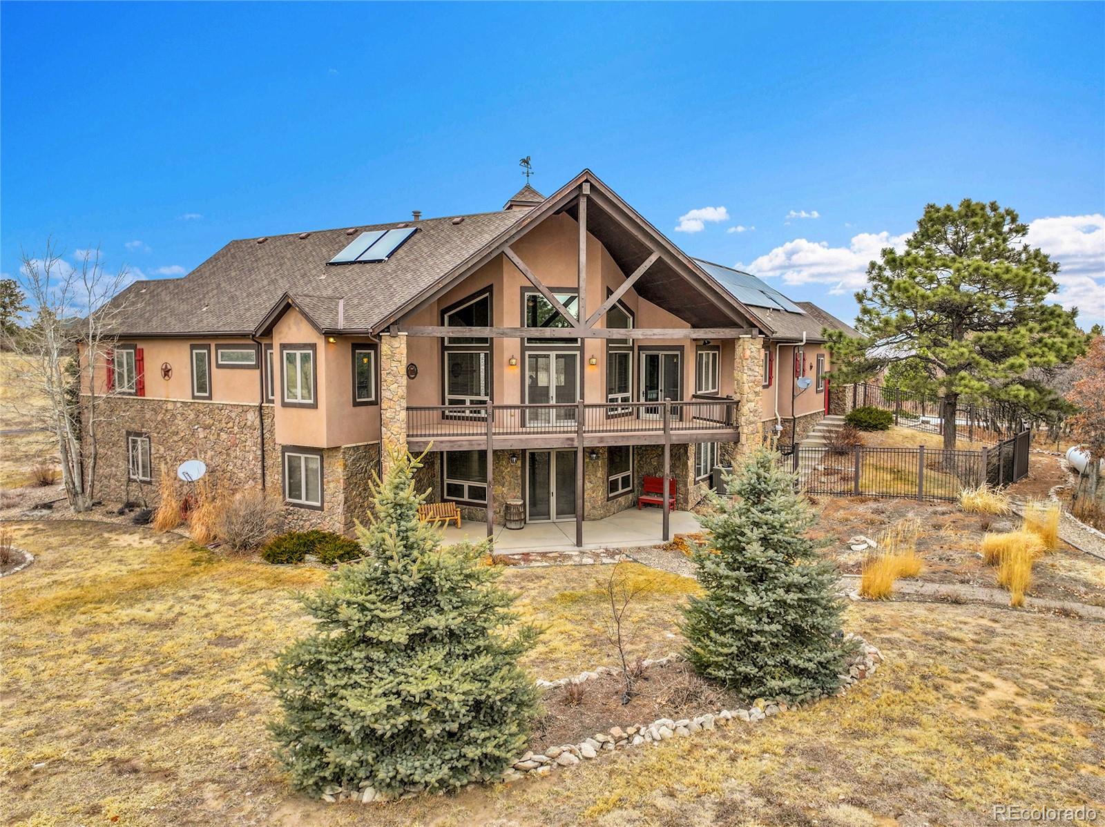 12984 Crowfoot Springs Road Franktown, CO 80116 - Photo 49 of 50 a front view of a house with a yard