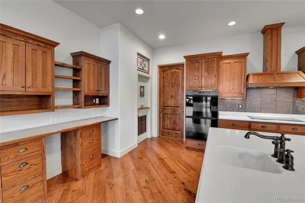 a kitchen with stainless steel appliances granite countertop a refrigerator and a stove top oven