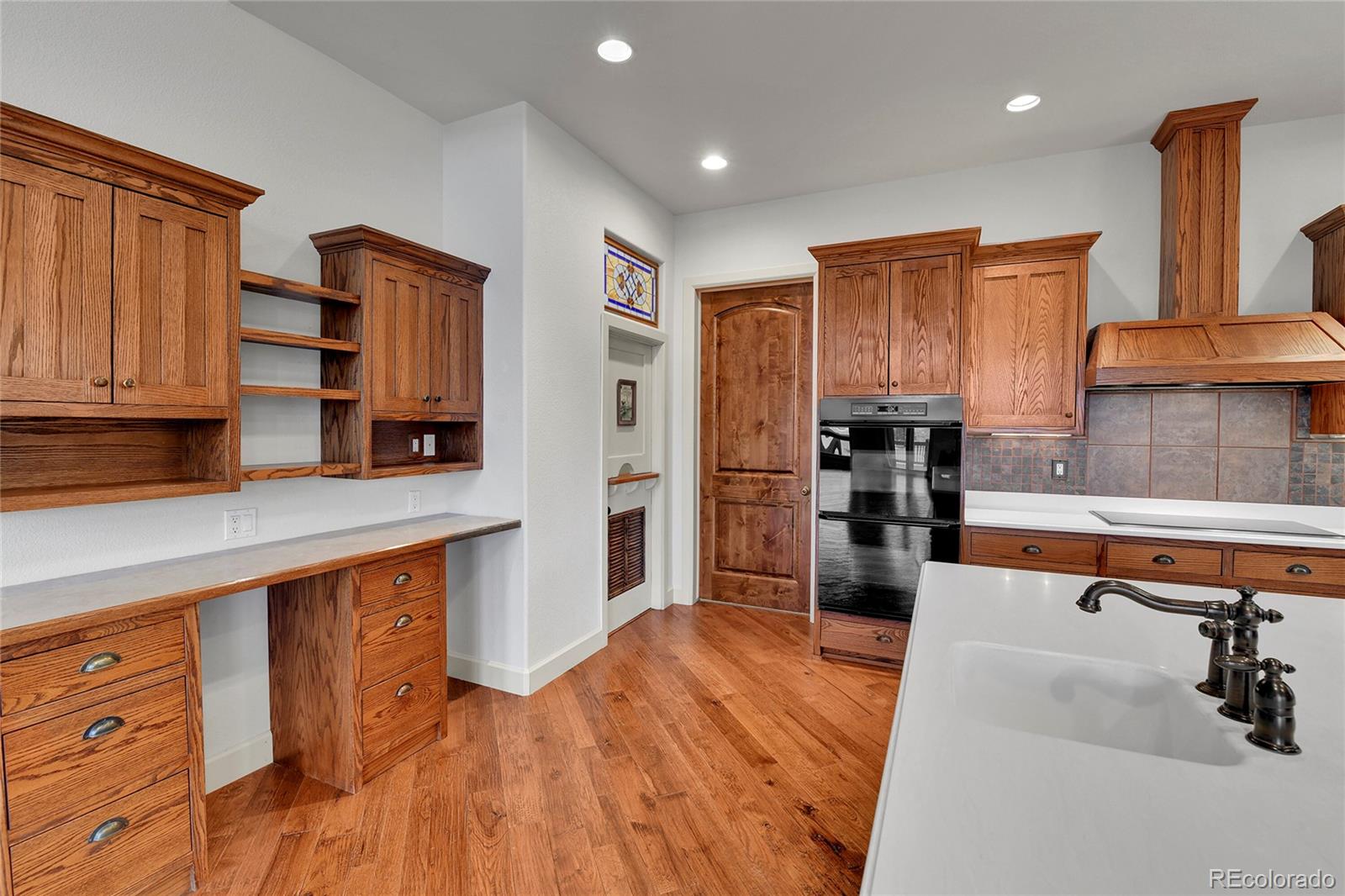 12984 Crowfoot Springs Road Franktown, CO 80116 - Photo 9 of 50 a kitchen with stainless steel appliances granite countertop a refrigerator and a stove top oven