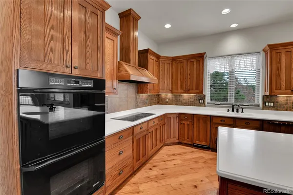 a kitchen with granite countertop a sink stainless steel appliances and cabinets
