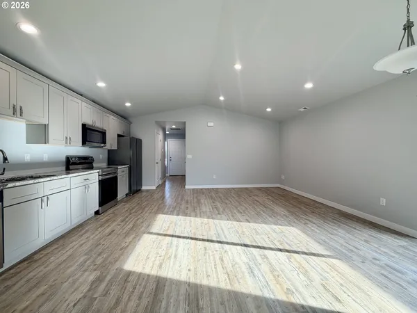 a view of kitchen with refrigerator sink and stove