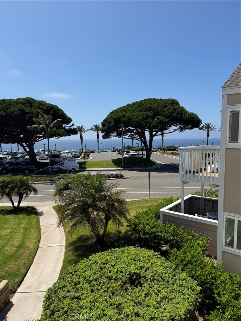 34112 Selva Road, Unit 333 Dana Point, CA 92629 - Photo 3 of 10 a view of a swimming pool with lawn chairs under an umbrella