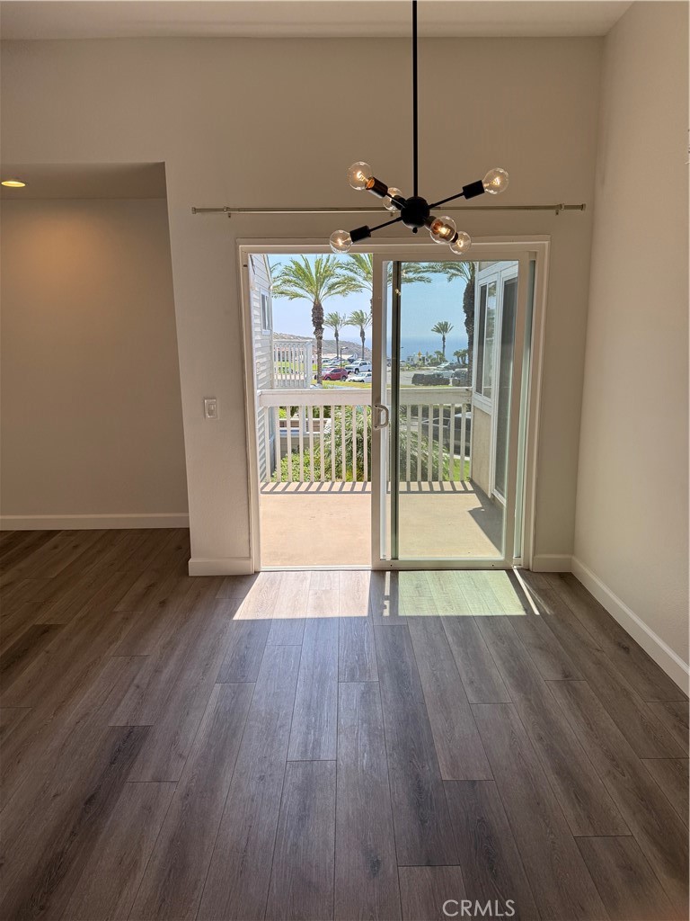 34112 Selva Road, Unit 333 Dana Point, CA 92629 - Photo 7 of 10 a view of an empty room with wooden floor