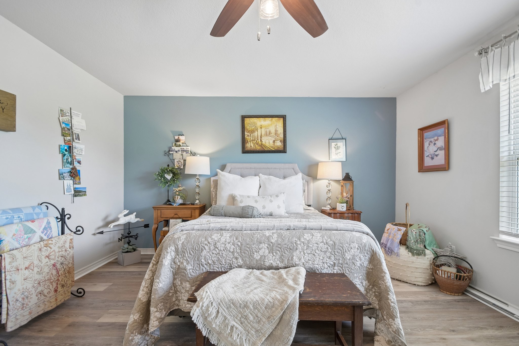 596 Pleasant Grove Loop Elgin, TX 78621 - Photo 20 of 37 Smooth wood-plank flooring and a large window create a serene and restful bedroom atmosphere.