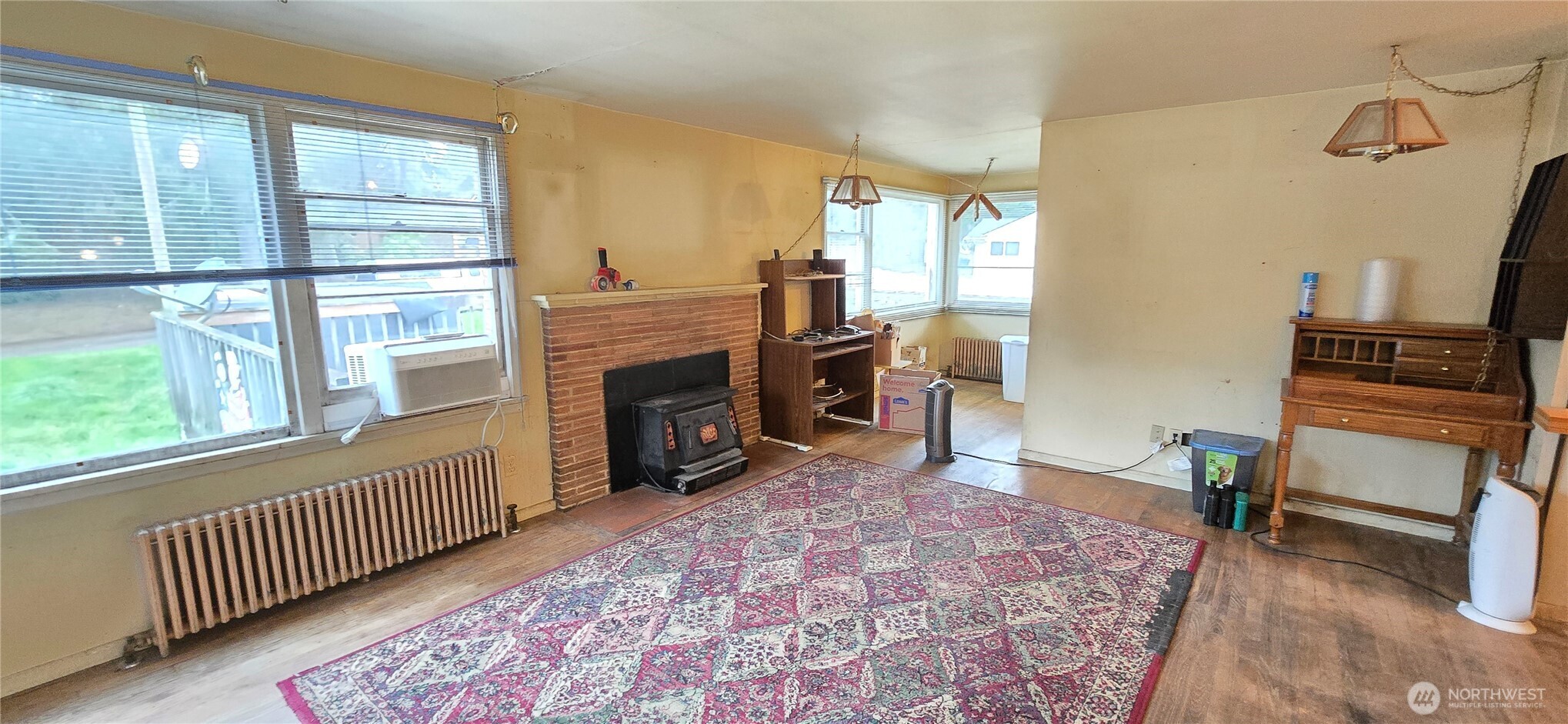 4821 164th Street Southwest Edmonds, WA 98026 - Photo 3 of 11 a living room with furniture a fireplace and a floor to ceiling window