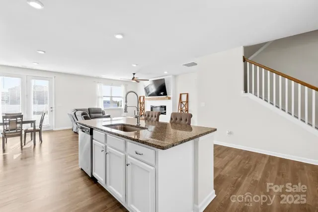 a kitchen with center island table and chairs