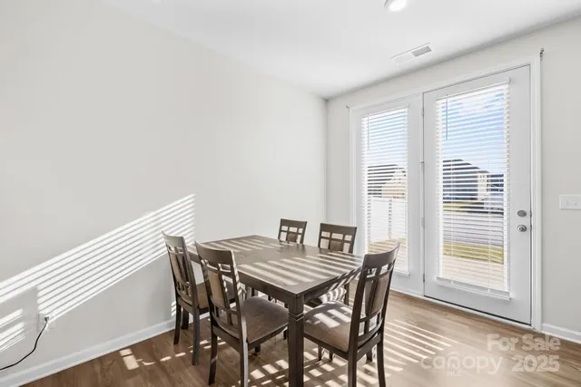 a view of a dining room with furniture and windows