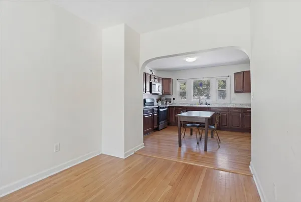 a living room with furniture and a dresser