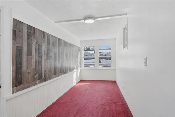 a view of hallway with wooden floor