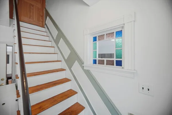 a view of balcony with wooden floor and fence