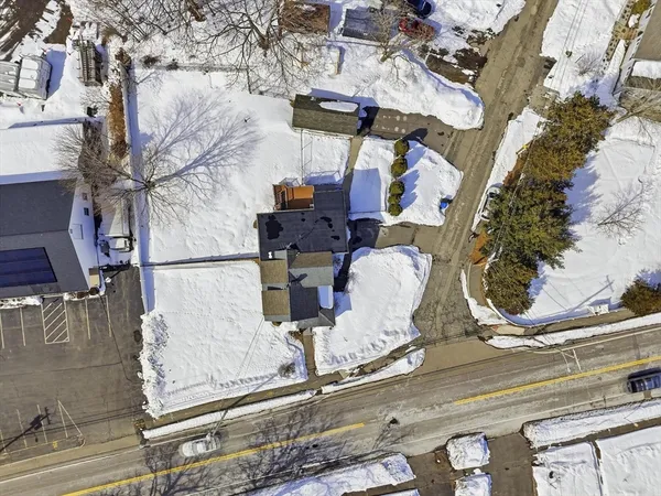 an aerial view of a house with a yard