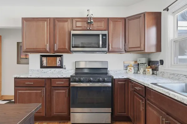 a view of room with a ceiling fan and wooden floor