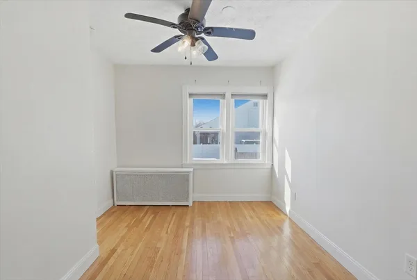 a workspace with wooden floor and a window