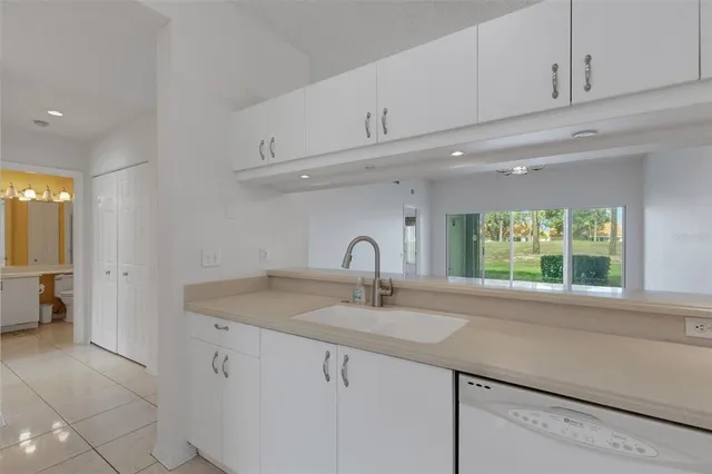 a utility room with cabinets washer and dryer