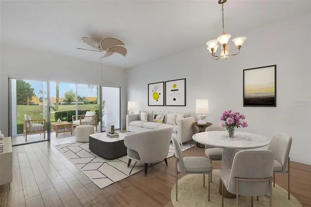 a dining room with wooden floor a chandelier a glass table and chairs