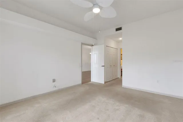 a view of a room with a floor to ceiling window and wooden floor