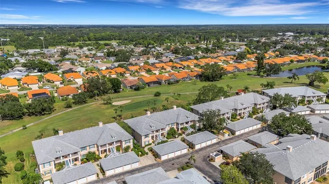 a view of a patio with a table and chairs under an umbrella