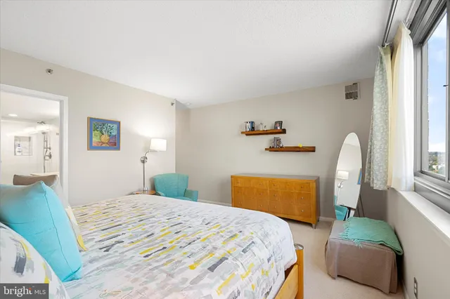 a bedroom with a bed and dresser