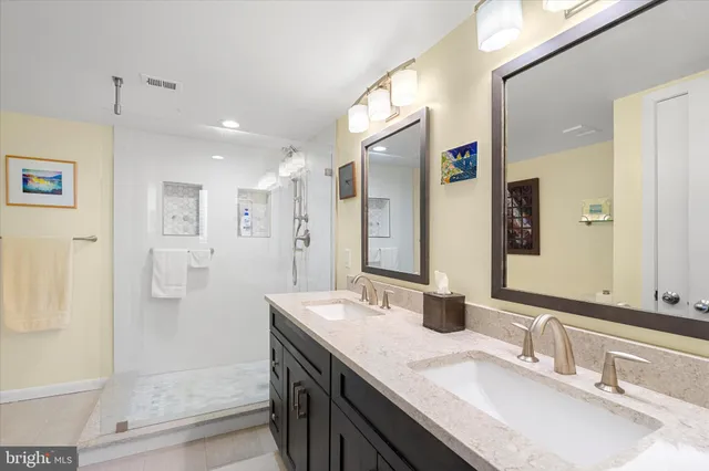 a bathroom with a granite countertop sink mirror and double