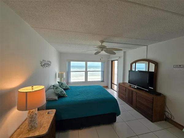 a bedroom with a bed closet and a window