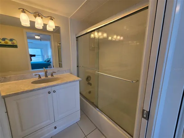 a bedroom with a bed and a mirror