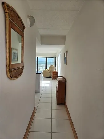 a room with granite countertop white cabinets and a large window