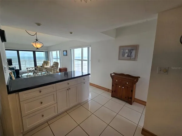 a kitchen with granite countertop a sink a stove and refrigerator