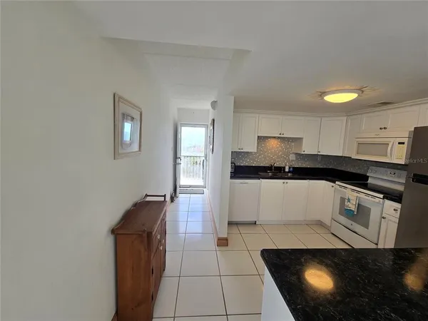 a view of a livingroom with furniture and a window