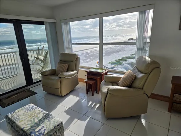 a living room with furniture a window and a table