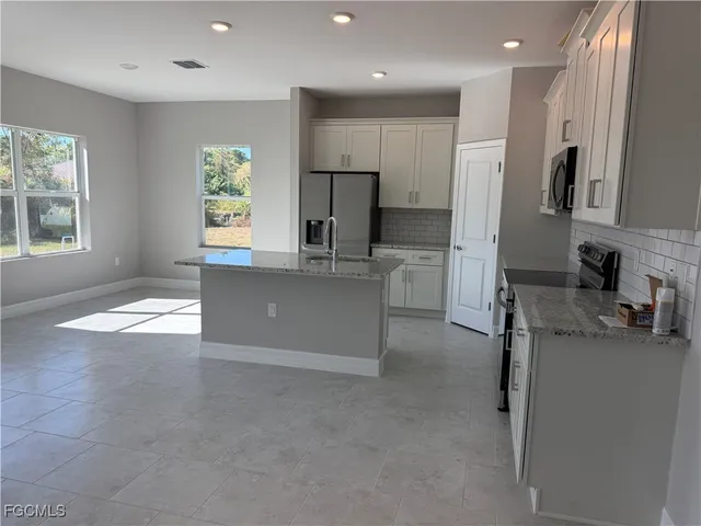 a kitchen with stainless steel appliances a refrigerator and a sink