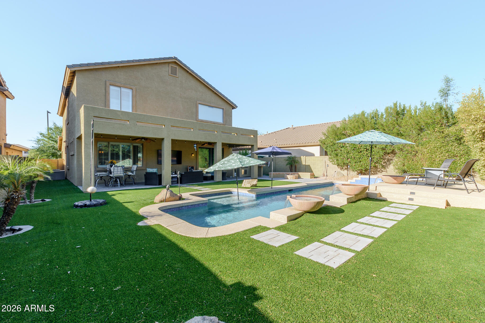 4521 West Moss Springs Road Anthem, AZ 85086 - Photo 4 of 35 a front view of a house with swimming pool having outdoor seating