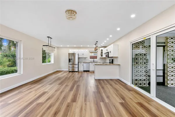 a view of kitchen with cabinets and wooden floor