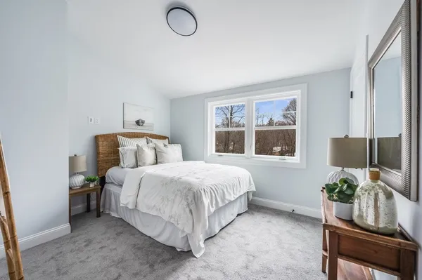 a bedroom with a bed and windows