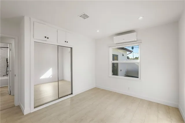an empty room with mirror and entrance