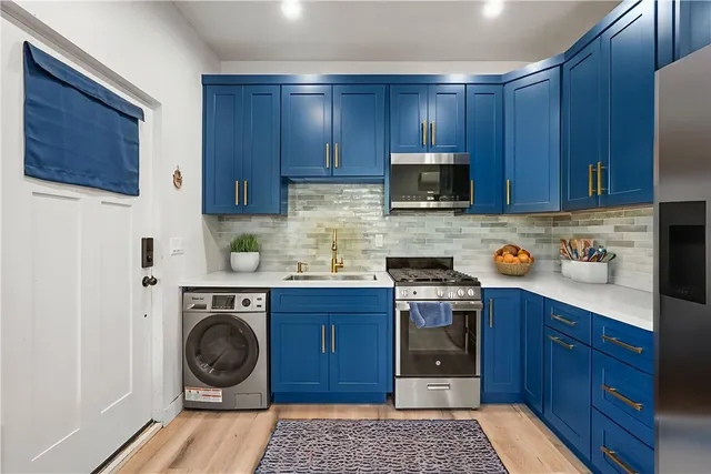 a kitchen with a stove top oven sink and cabinets