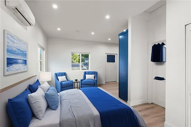 a bed room with a bed a couch and a window