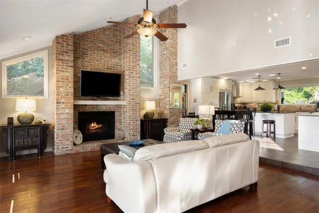 a living room with furniture a fireplace and a flat screen tv
