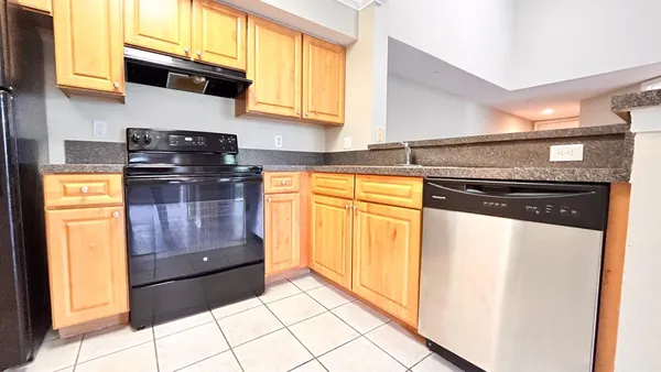 a kitchen with granite countertop cabinets and steel stainless steel appliances