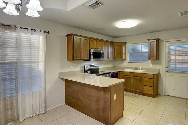 a kitchen with a sink stove and microwave