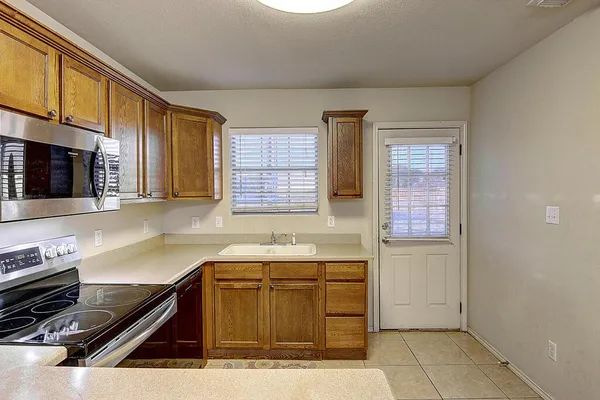 a kitchen with a sink cabinets and window