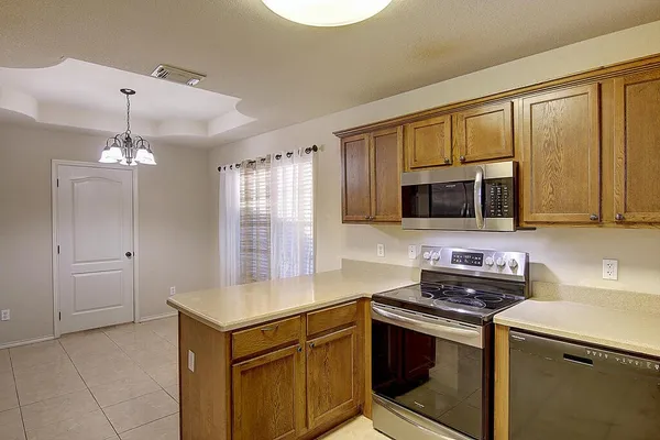 a kitchen with stainless steel appliances granite countertop a sink and a microwave