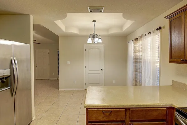 a view of a kitchen with a dishwasher and a refrigerator
